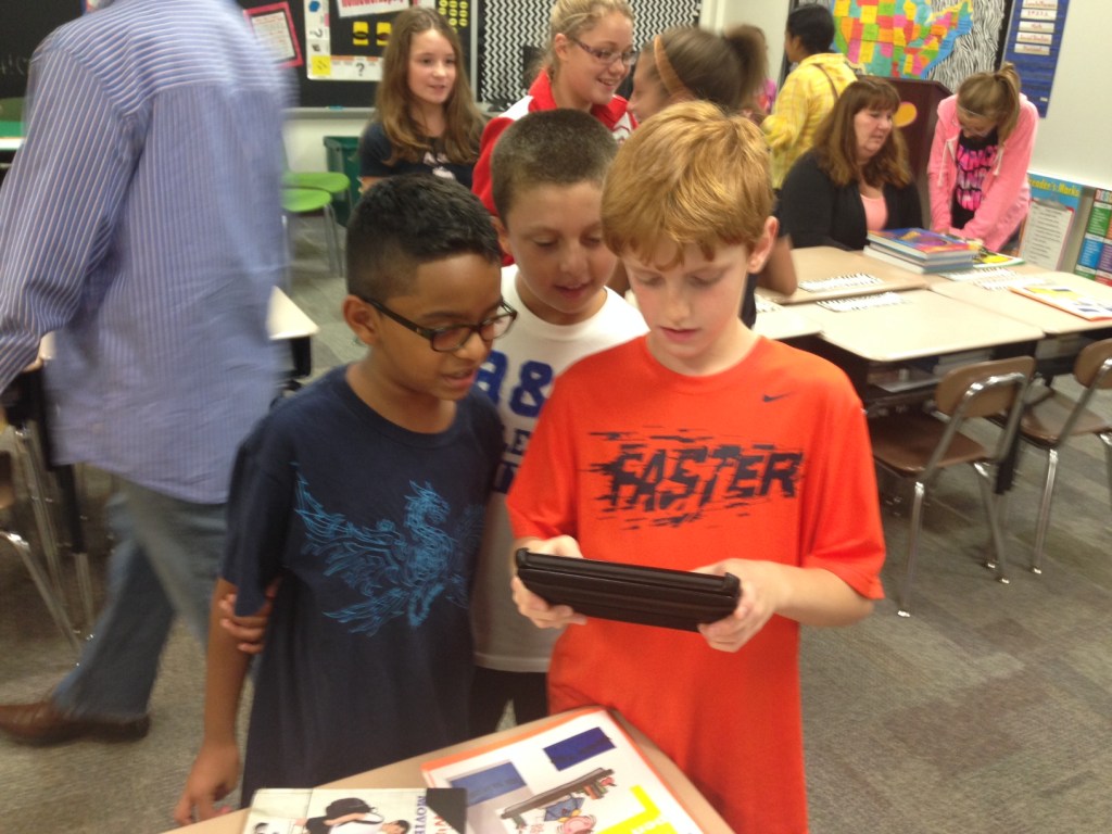 Young students working with electronic tablet.
